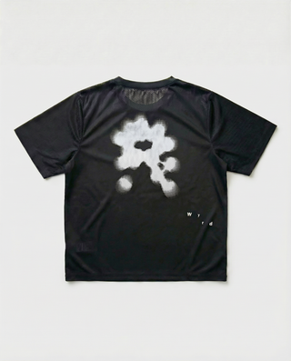 Black t-shirt with a white floral design on the back against a light gray background